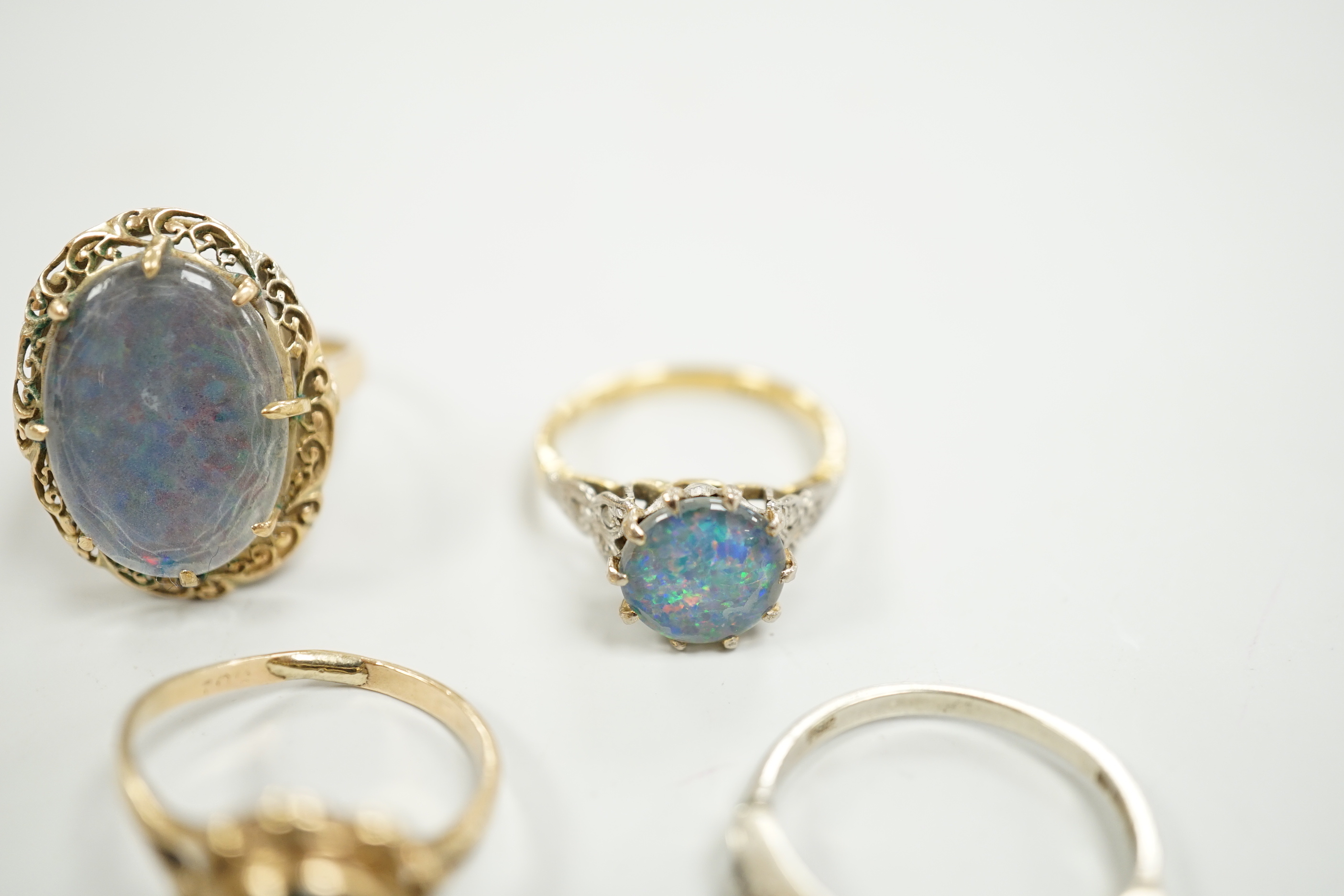 A 1940's 18ct and black opal doublet set dress ring, with diamond chip set shoulders, size L, a 14c and oval doublet ring and two other 9ct and gem set rings.